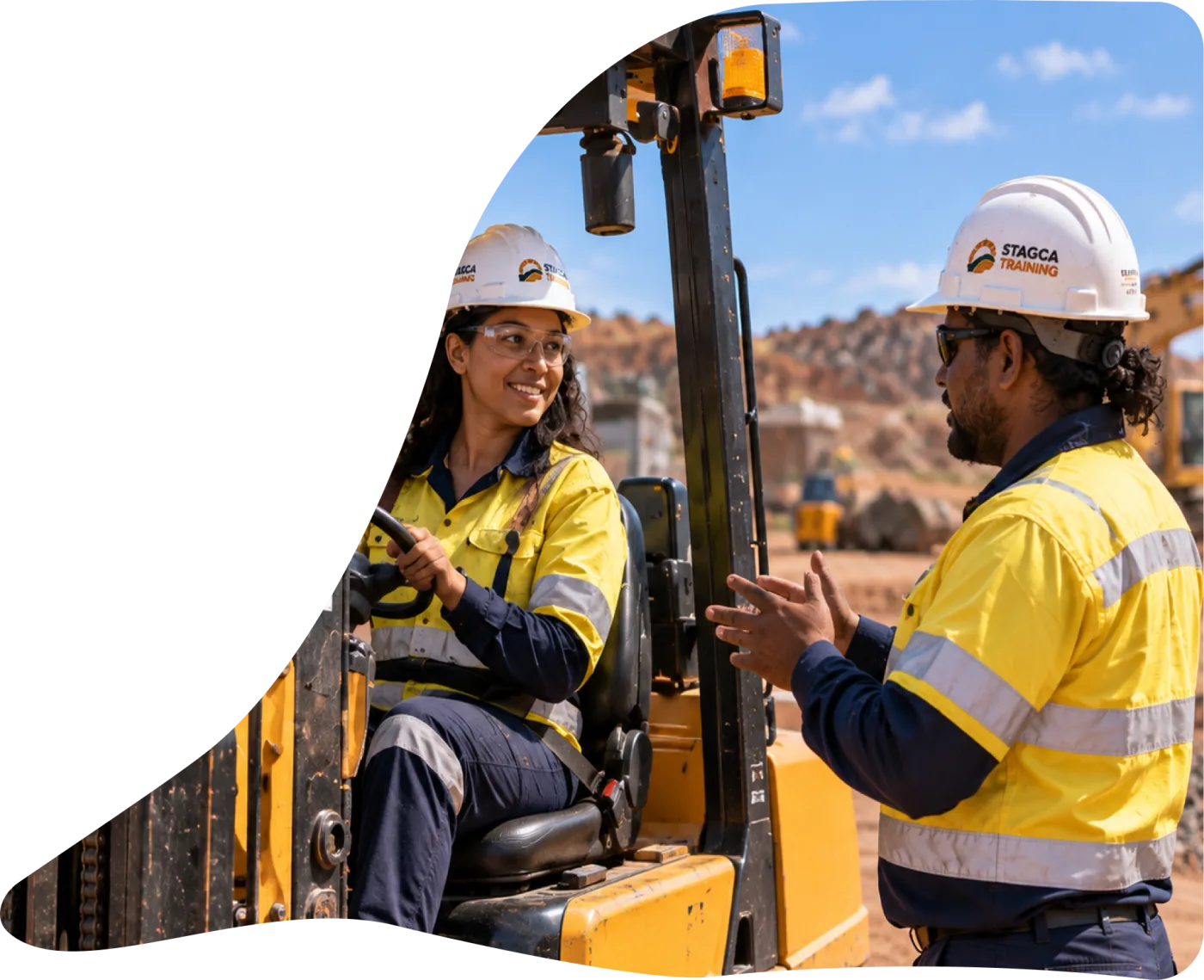 Trainer coaching an operator in a loader cab
